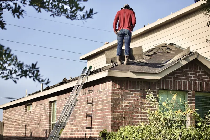 Professional roofer working on a residential roof in Eastridge